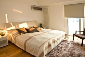 Modern bedroom with a ductless mini split AC unit installed above the bed.
